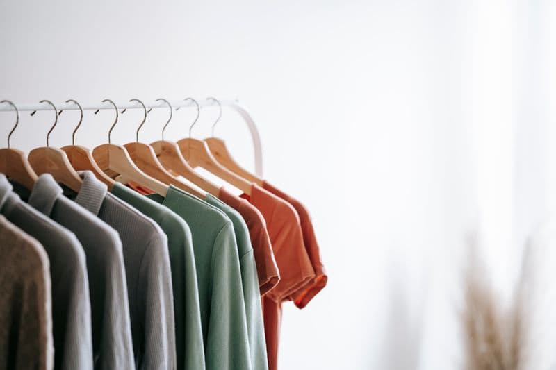 Muted tees hanging on a studio rack, apparel goodies ready to press.